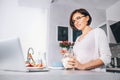 Woman prepare breakfast and watch a news in laptop Royalty Free Stock Photo