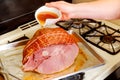 Woman prepare holiday spiral sliced pork ham Royalty Free Stock Photo