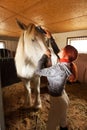 Woman prepare horse for riding