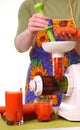 Woman prepare Juice extractor and carrot Royalty Free Stock Photo