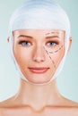 Woman prepared for plastic surgery head covered in bandage cosmetic surgery