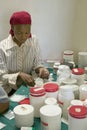 A woman prepares AIDS pills at Pepo La Tumaini Jangwani, HIV/AIDS Community Rehabilitation Program, Orphanage & Clinic. Pepo La T