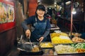 A woman prepares Asian street food in the north of Thailand, Pai