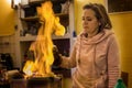 Woman prepares a fire tongs punch