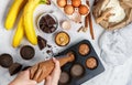 Woman prepares homemade muffins with banana and chocolate Royalty Free Stock Photo