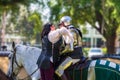 A woman prepares a knight for a joust at Camelot Days Medieval Festival - Topeekeegee Yugnee TY Park, Hollywood, Florida, USA