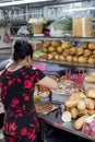 Woman prepares a sandwich in a street of Ho Chi Minh City, Vietnam