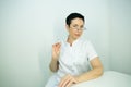 Dr. cometologist. A woman prepares a syringe with medication to correct wrinkles