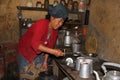A woman prepares Tongba aka Nepali Beer from fermented millet in a guest house in Bhedetar