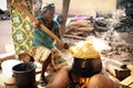 A woman prepares corn porridge in Winneba, Ghana