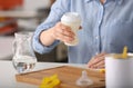 Woman preparing baby formula at table Royalty Free Stock Photo