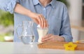 Woman preparing baby formula at table Royalty Free Stock Photo