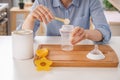 Woman preparing baby formula at table Royalty Free Stock Photo