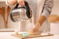 Woman preparing baby milk formula in kitchen Royalty Free Stock Photo