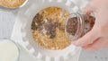 Woman preparing breakfast. Oatmeal made with whole grain oats, flaxseed meal, Chia seeds, and milk, flat lay Royalty Free Stock Photo