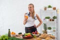 Woman preparing dinner in a kitchen, drinking Royalty Free Stock Photo