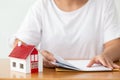 Woman preparing documents file for loan home.