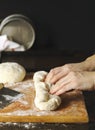 Woman preparing dough for french baguette