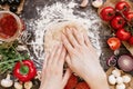 Woman preparing dough for pizza. Hands kneading dough on the wooden table, top view Royalty Free Stock Photo