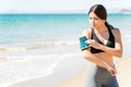 Woman Preparing Before Exercising On Beach Royalty Free Stock Photo