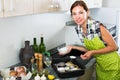 Woman preparing fish on kitchen Royalty Free Stock Photo