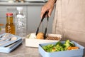 Woman preparing food for her child at table in kitchen. Healthy school lunch Royalty Free Stock Photo