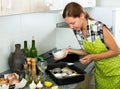 Woman preparing fresh codfish at kitchen Royalty Free Stock Photo
