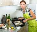 Woman preparing fresh codfish at kitchen Royalty Free Stock Photo