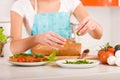 Woman preparing fresh healthy sandwiches in h