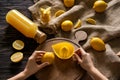 Woman preparing fresh lemon juice in kitchen, top view Royalty Free Stock Photo