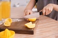 Woman preparing fresh lemon juice in kitchen Royalty Free Stock Photo