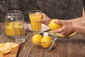 Woman preparing fresh lemon juice at wooden table Royalty Free Stock Photo