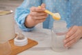 Woman preparing infant formula at table indoors, closeup. Baby milk Royalty Free Stock Photo