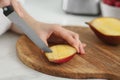 Woman preparing mango for tasty smoothie at white marble table, closeup Royalty Free Stock Photo