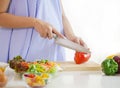 woman preparing meal at table in the kitchen, healthy nutrition during pregnancy Royalty Free Stock Photo