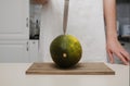 a cook in the kitchen cuts a ripe melon, close-up of hands Royalty Free Stock Photo