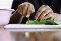 Woman Preparing Nigerian Okra Okra for storage in a fridge