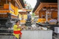 Woman preparing offering at Goa Gajah temple, Elephant cave, famous landmark Hindu, Bali, Indonesia,14.08.2018 Royalty Free Stock Photo