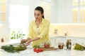 Woman preparing pickled vegetables in kitchen