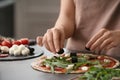 Woman preparing pizza at table in kitchen Royalty Free Stock Photo