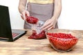 Woman preparing red currants in bowl for frozing,making jam in jars at home kitchen for winter.peeling summer fruits Royalty Free Stock Photo