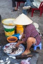 Woman is preparing seafood for sale at the market street