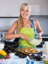 Woman preparing tigres espanol with mussels indoors