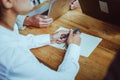 Woman preparing to write in notebook. Woman holds pen and open notebook is ready to write down ideas while discussing