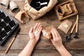 Woman preparing vegetable seeds for planting at wooden table Royalty Free Stock Photo