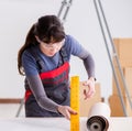 Woman preparing for wallpaper work Royalty Free Stock Photo
