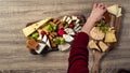 Woman prepearing table with wine appetize and cheese plates dinner