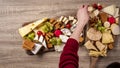 Woman prepearing table with wine appetize and cheese plates dinner