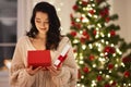 Woman With Present in the Gift Box Near Christmas Tree at Home Royalty Free Stock Photo