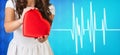 Woman present heartbox beside pulse line Royalty Free Stock Photo